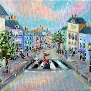 A young woman is pulled across a pretty street of pastel-coloured shops and houses by her Dalmatian.