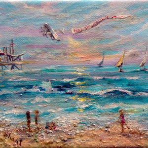 Beach scene with people along shore, a pier in the distance, sailboats on the water and a plane pulling a banner in the sky.
