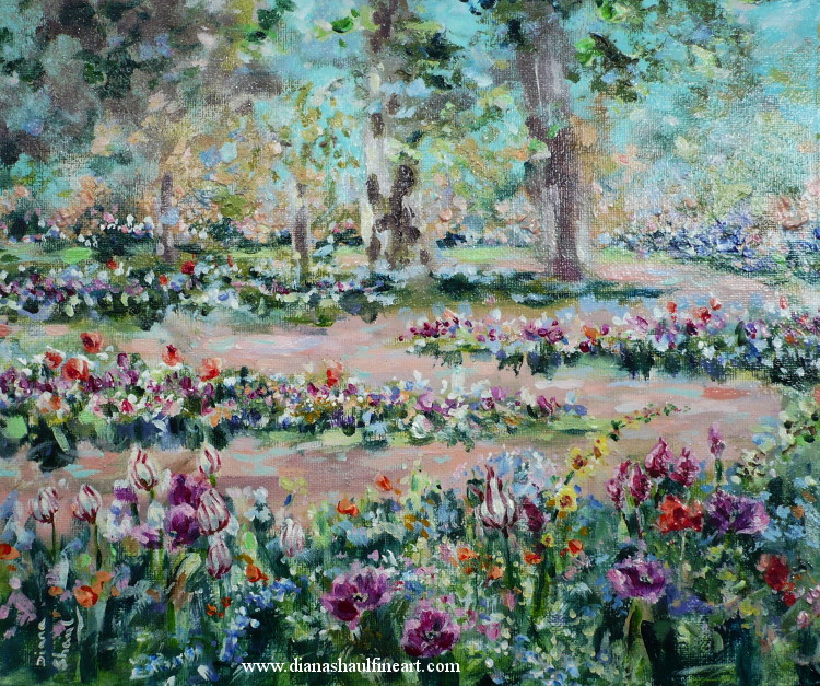 Original landscape depicting manicured flower beds of spring flowers, with a path winding around them and mature trees.